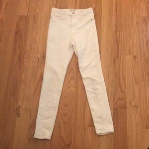These are white skinny jeans with a gold button on the front